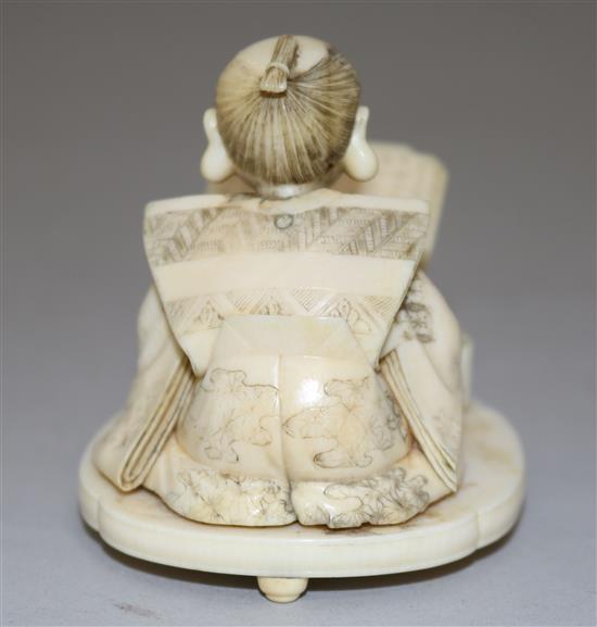 A Japanese Meiji ivory okimono of a scribe, 2.5in.